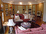 Natural hickory library units with a hidden door in center section